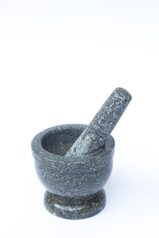 Stone mortar and pestle isolated on a white background photo