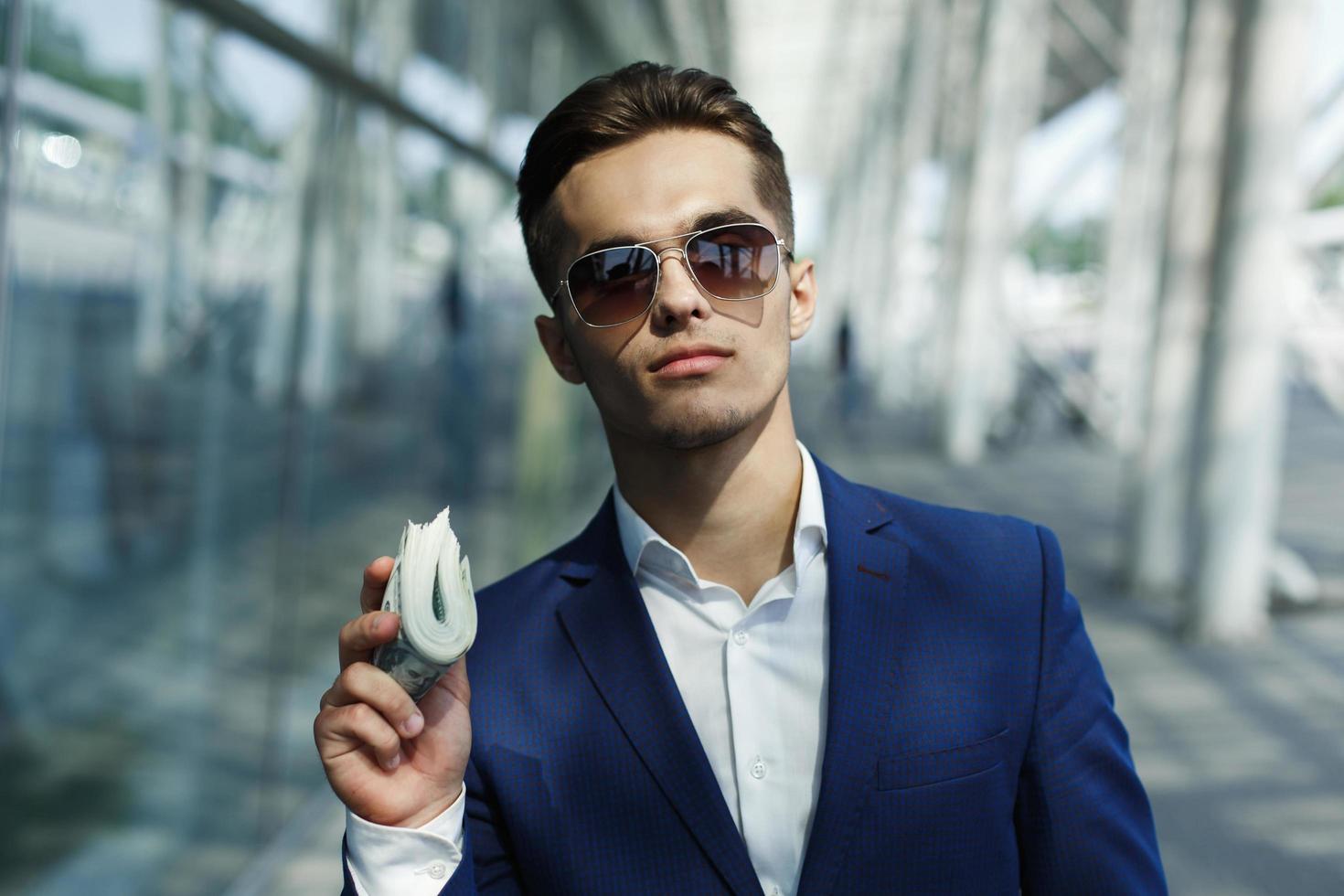 Man holding a bundle of cash photo