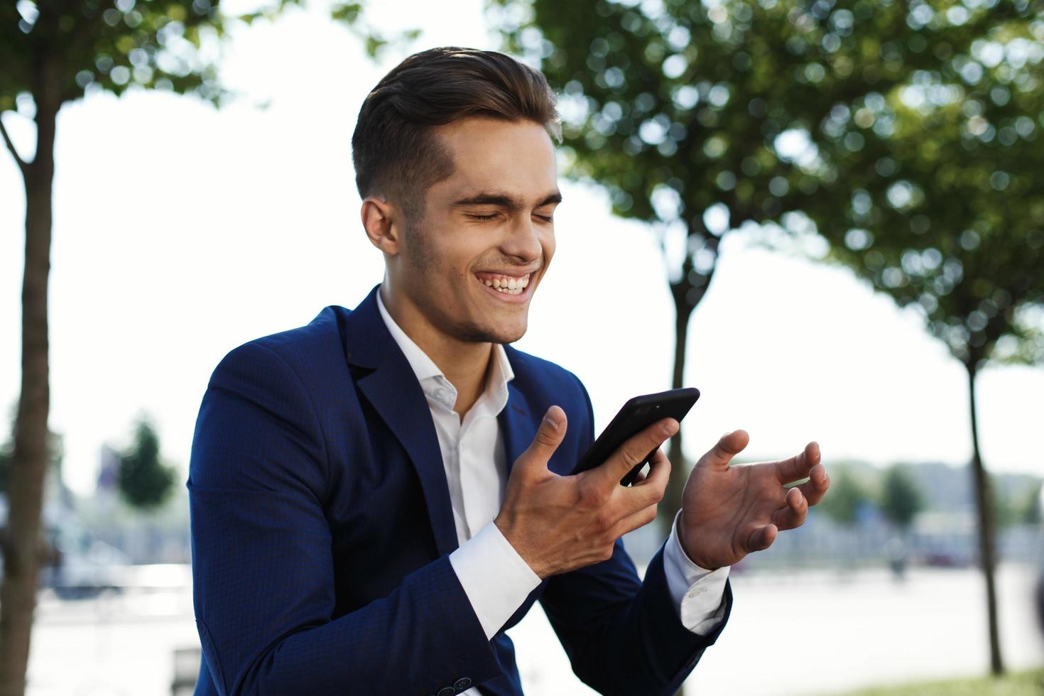 Man laughing into his phone photo