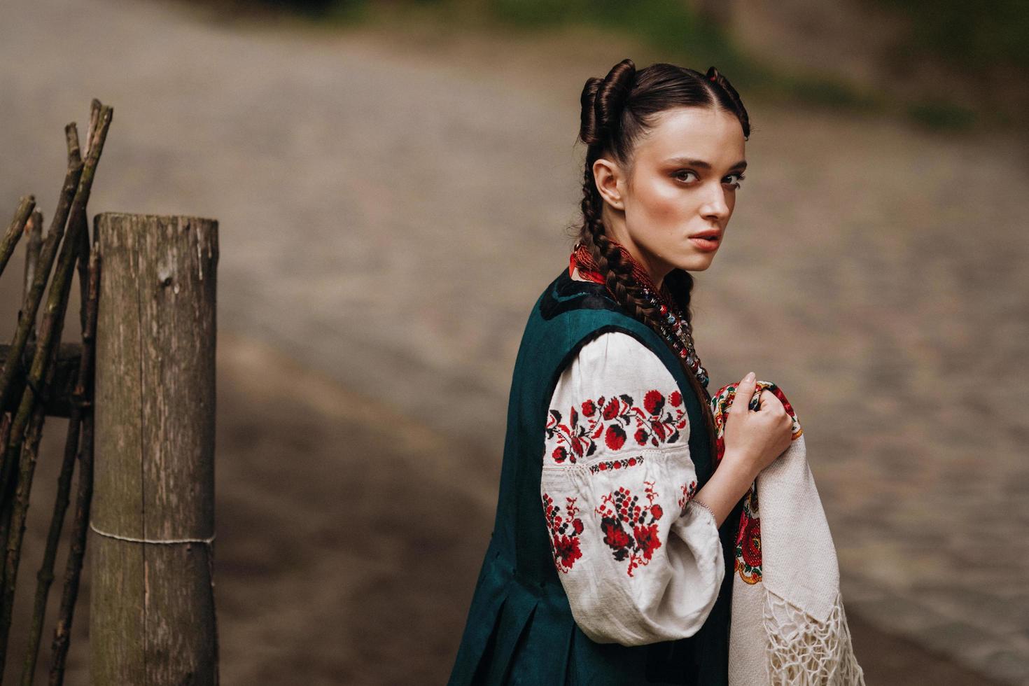 Charming girl in the Ukrainian traditional dress is walking photo