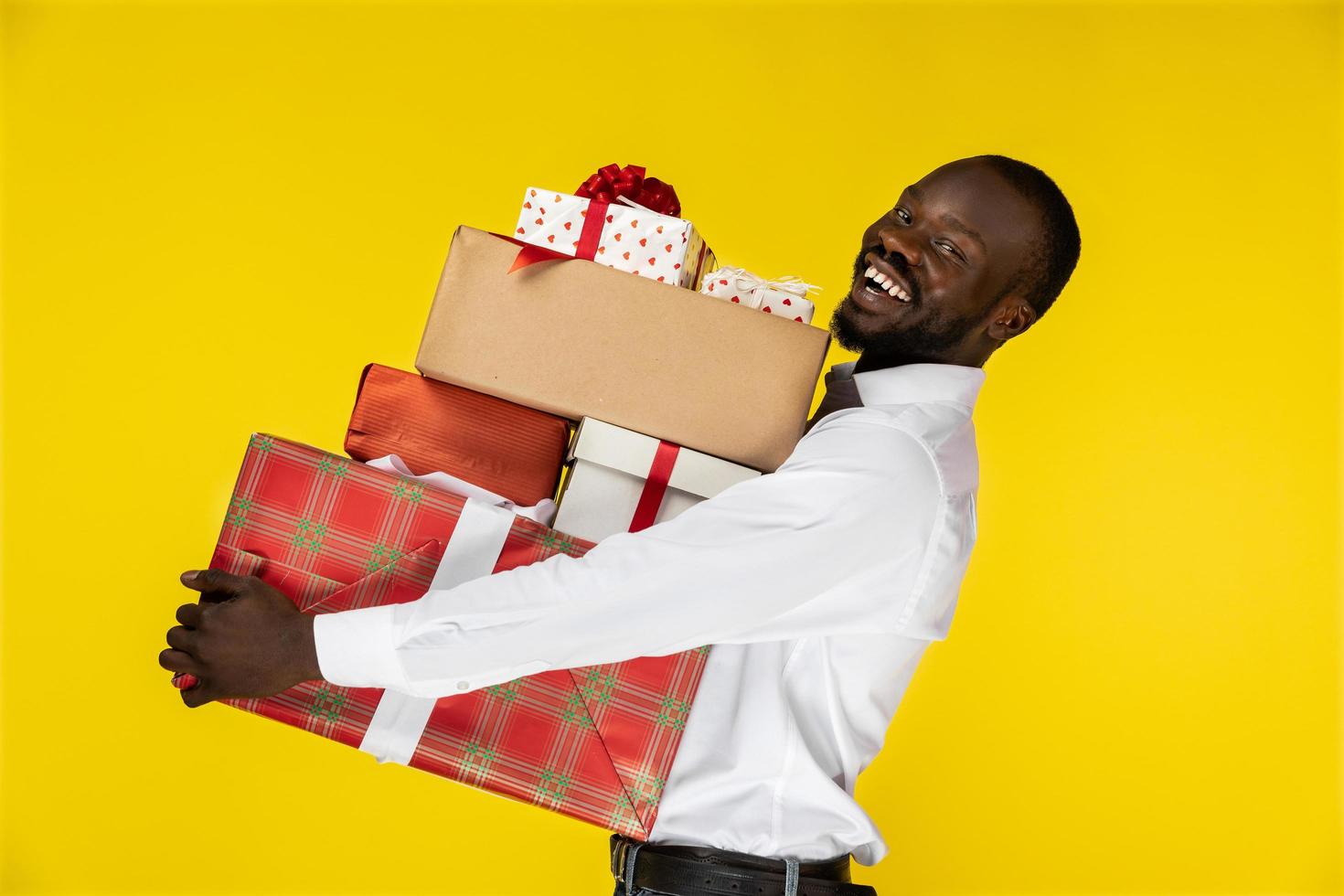 Man holding a stack of gifts photo