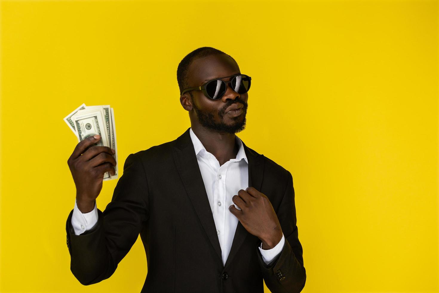 Man in a suit and sunglasses holding money photo