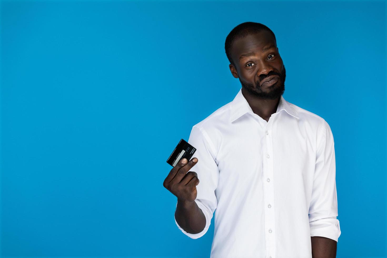 Man in white shirt holding a credit card photo