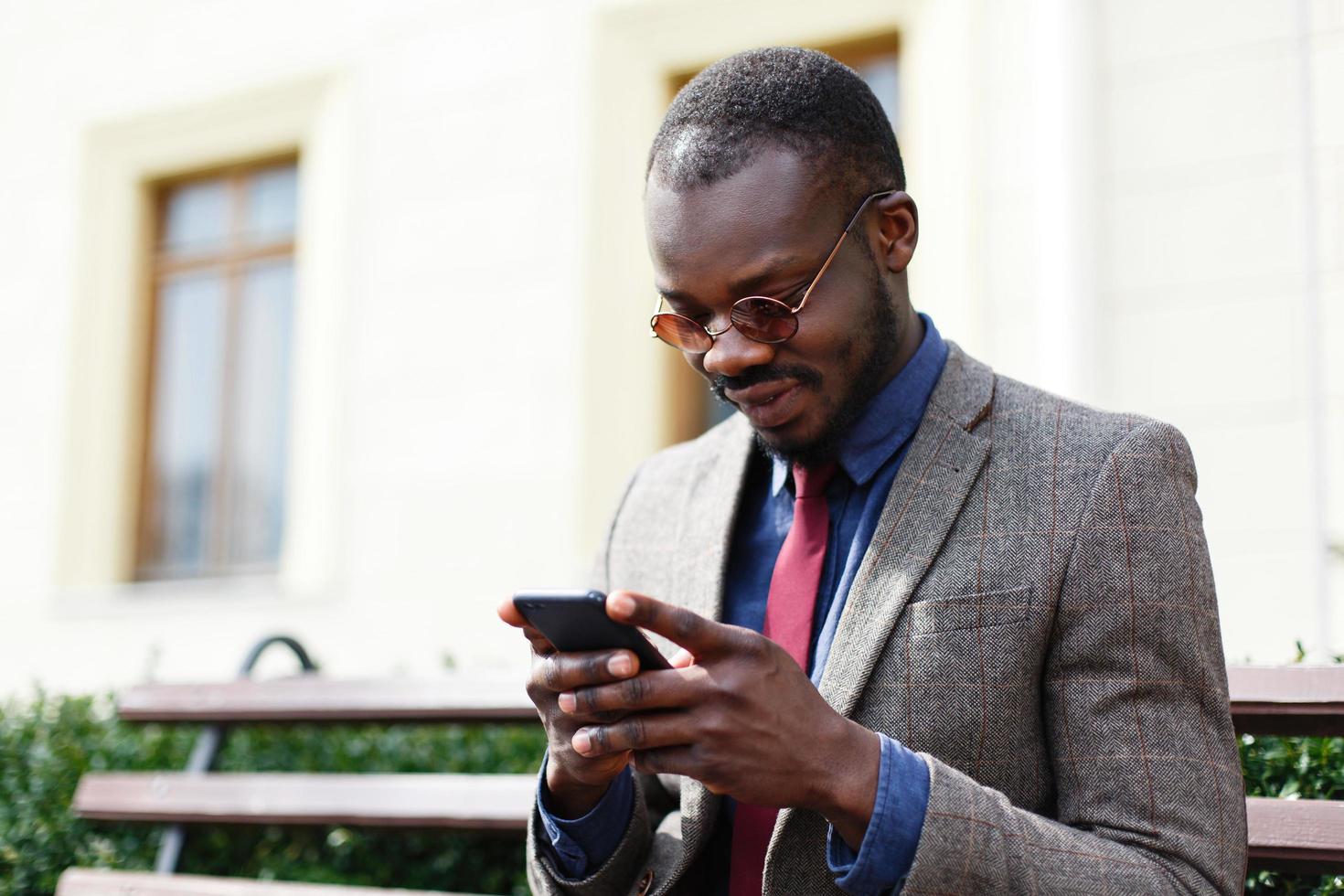 Business man works on his smartphone photo