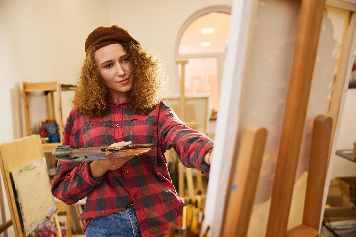 Curly haired girl painting photo