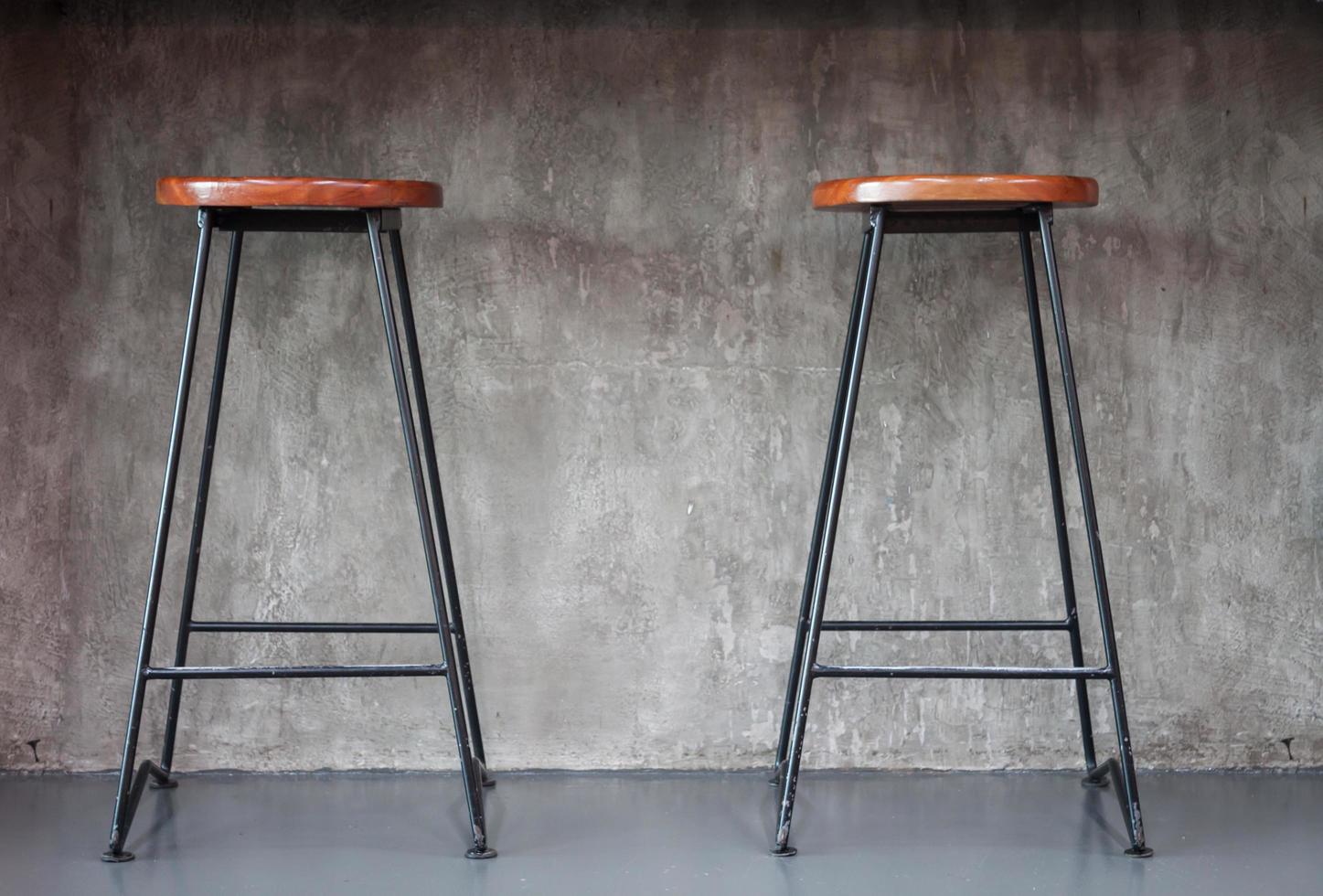 Wooden stools on a gray background photo