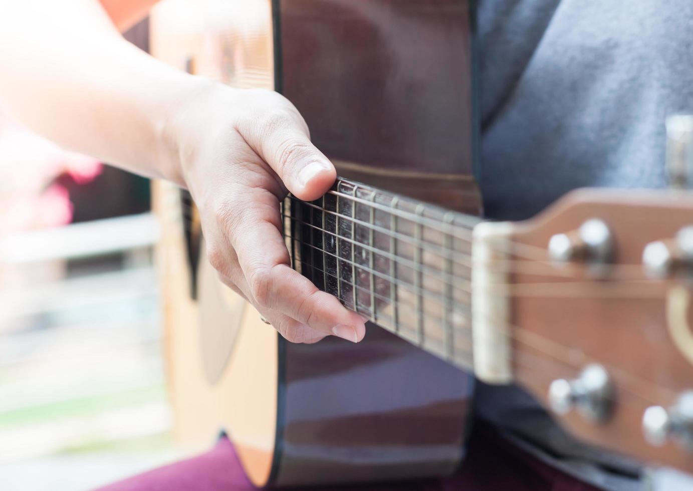 primer plano, de, un, persona que sostiene una guitarra foto