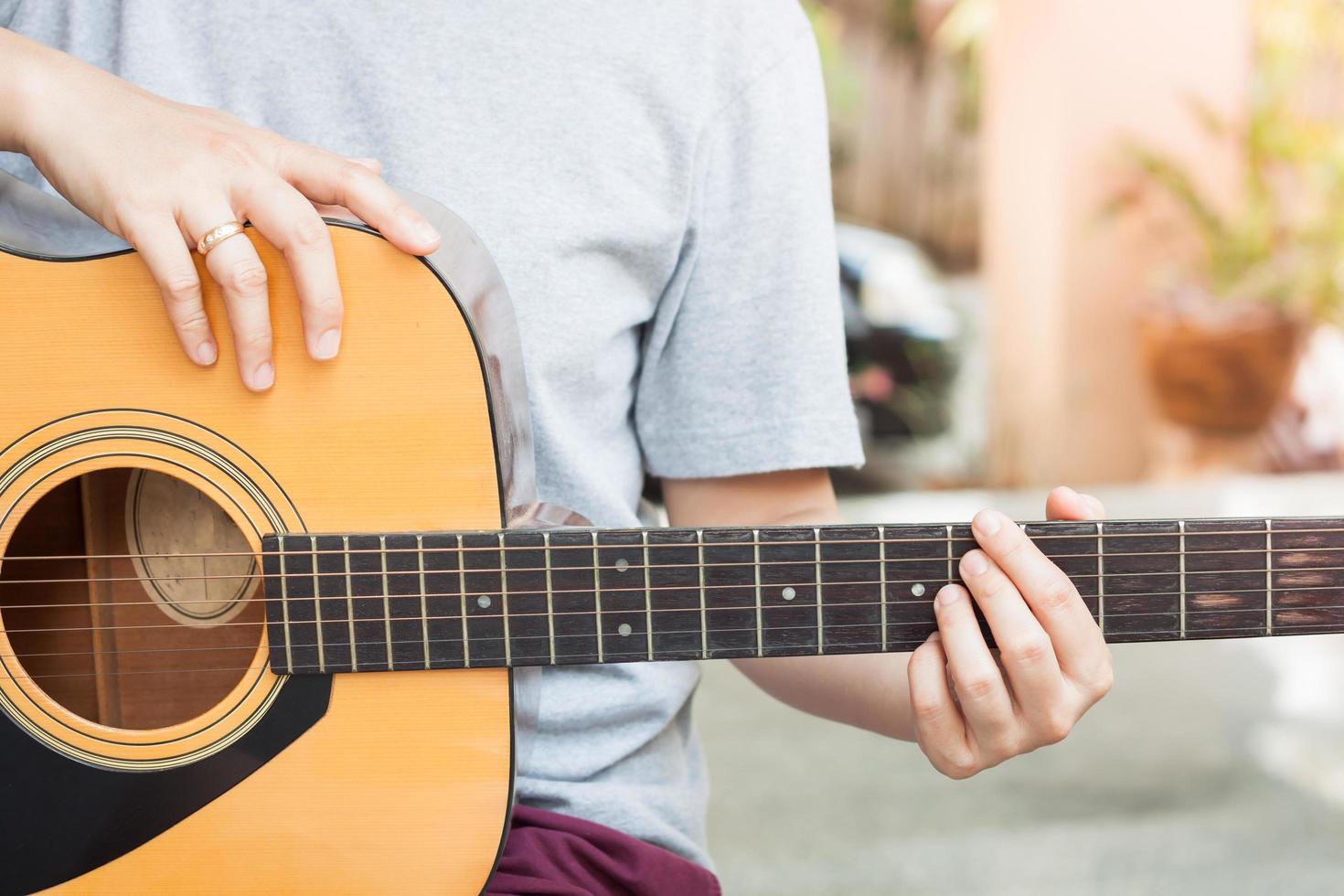Person playing a guitar photo