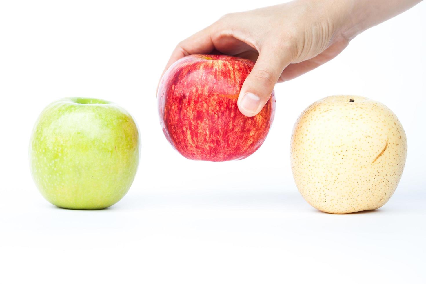 Hand picking up an apple photo