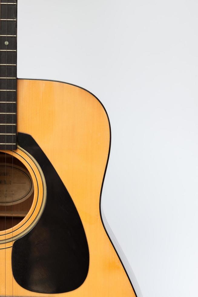 Acoustic guitar against a white background photo