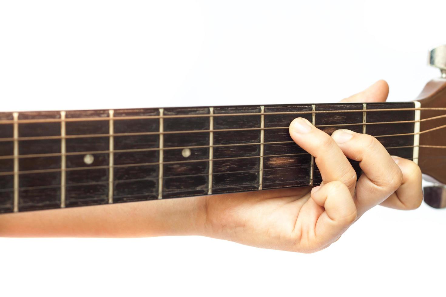 Close-up of fingers on a guitar neck photo