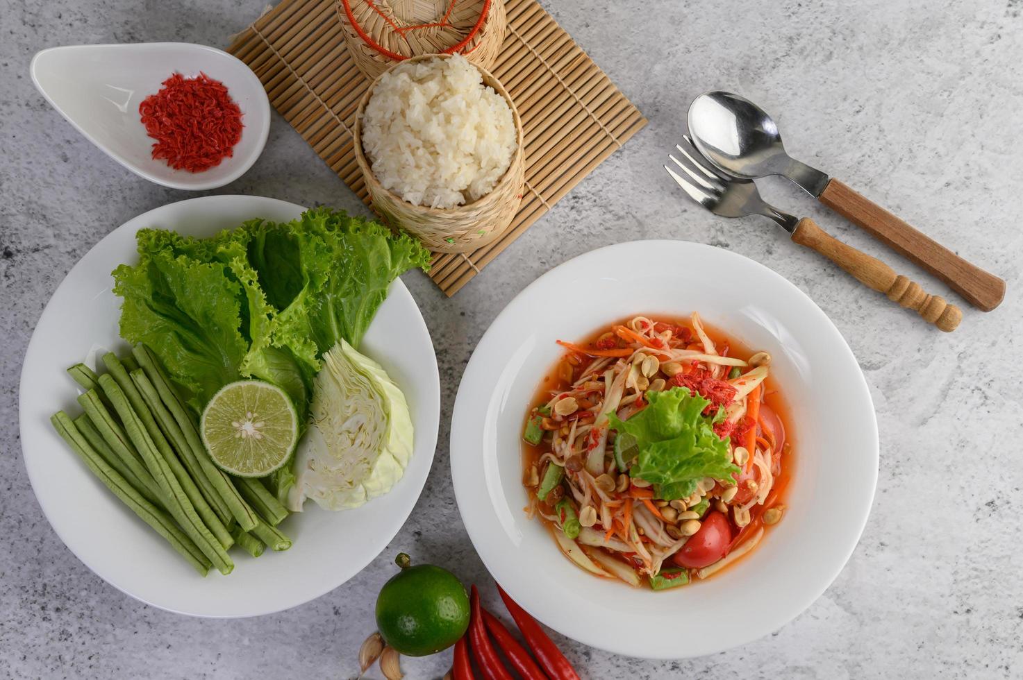 Thai papaya salad with sticky rice, lime and chili photo