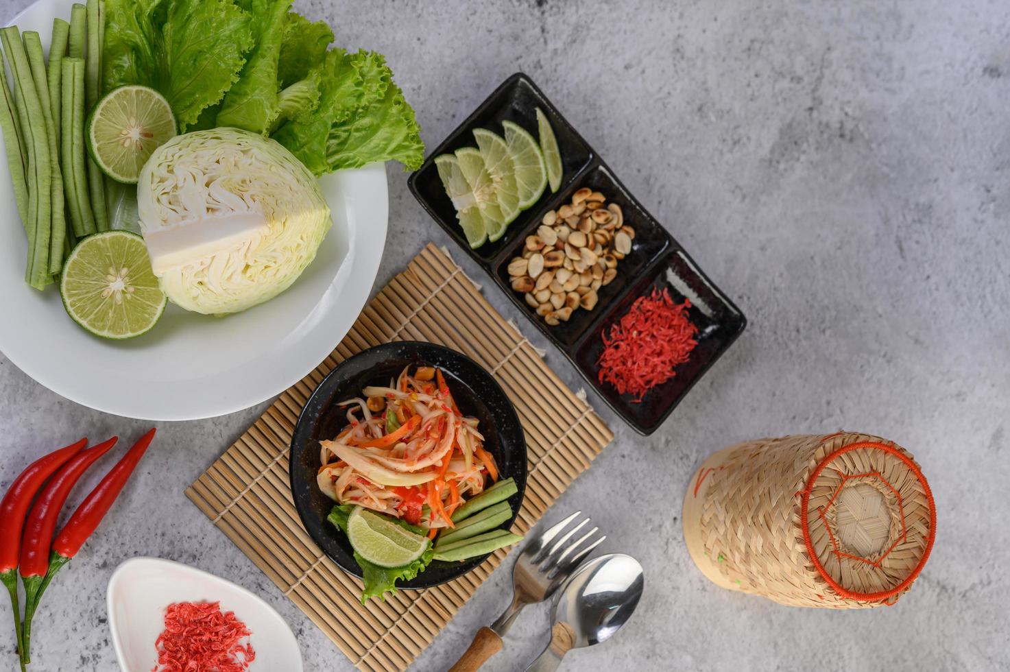 Thai papaya salad and ingredients photo