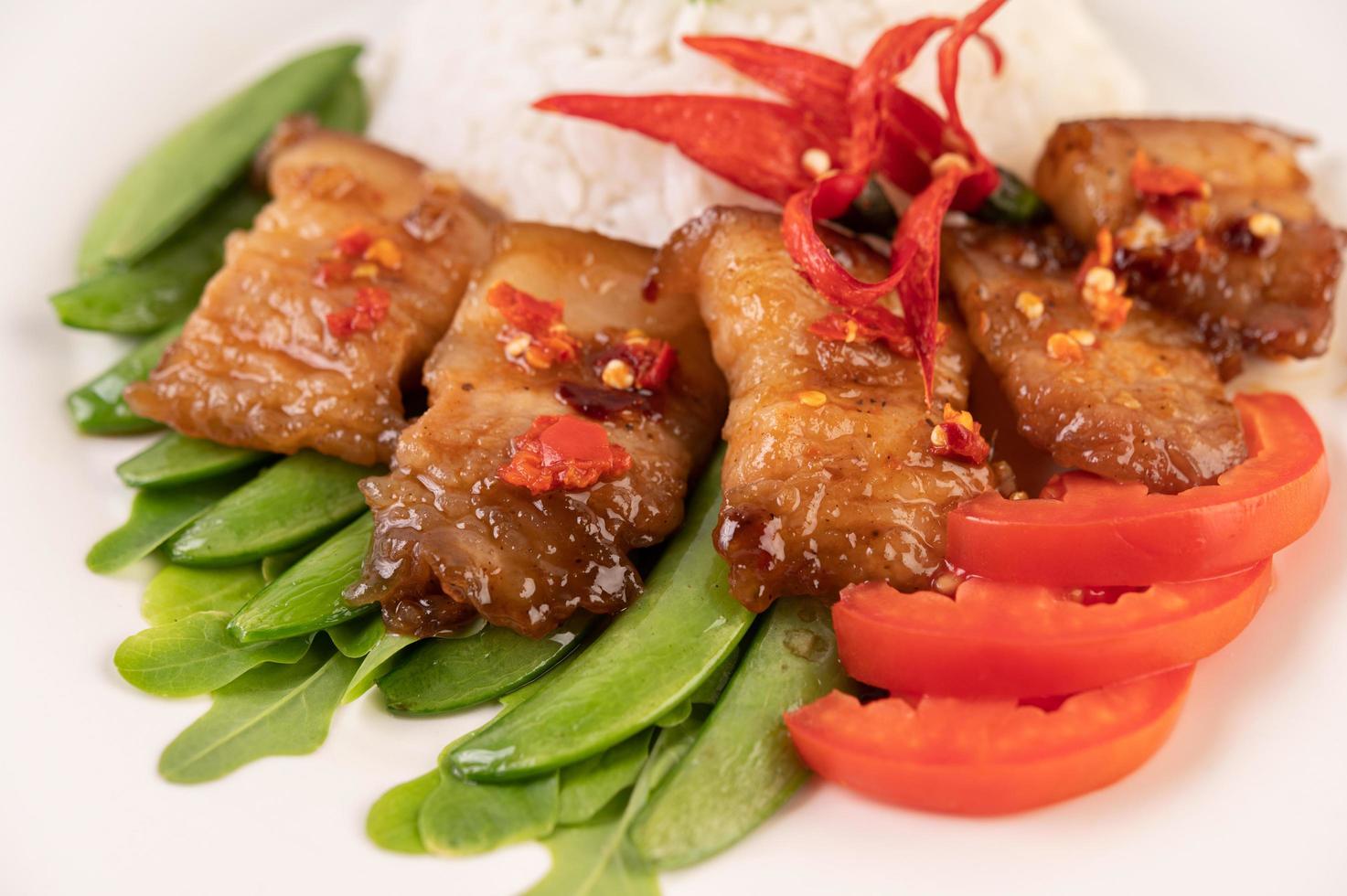 Pork belly on steamed rice photo