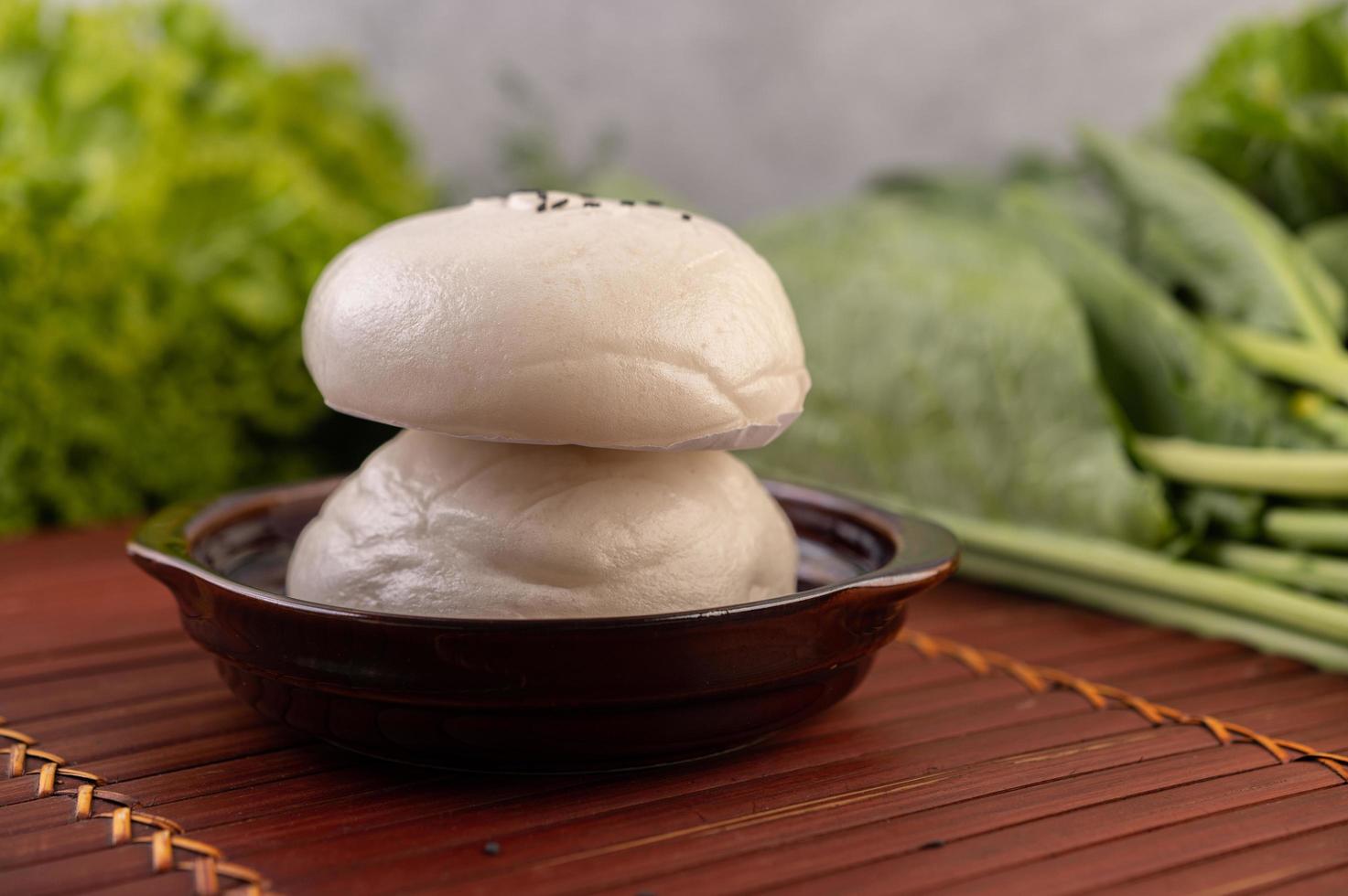 Steamed buns in a wooden dish photo