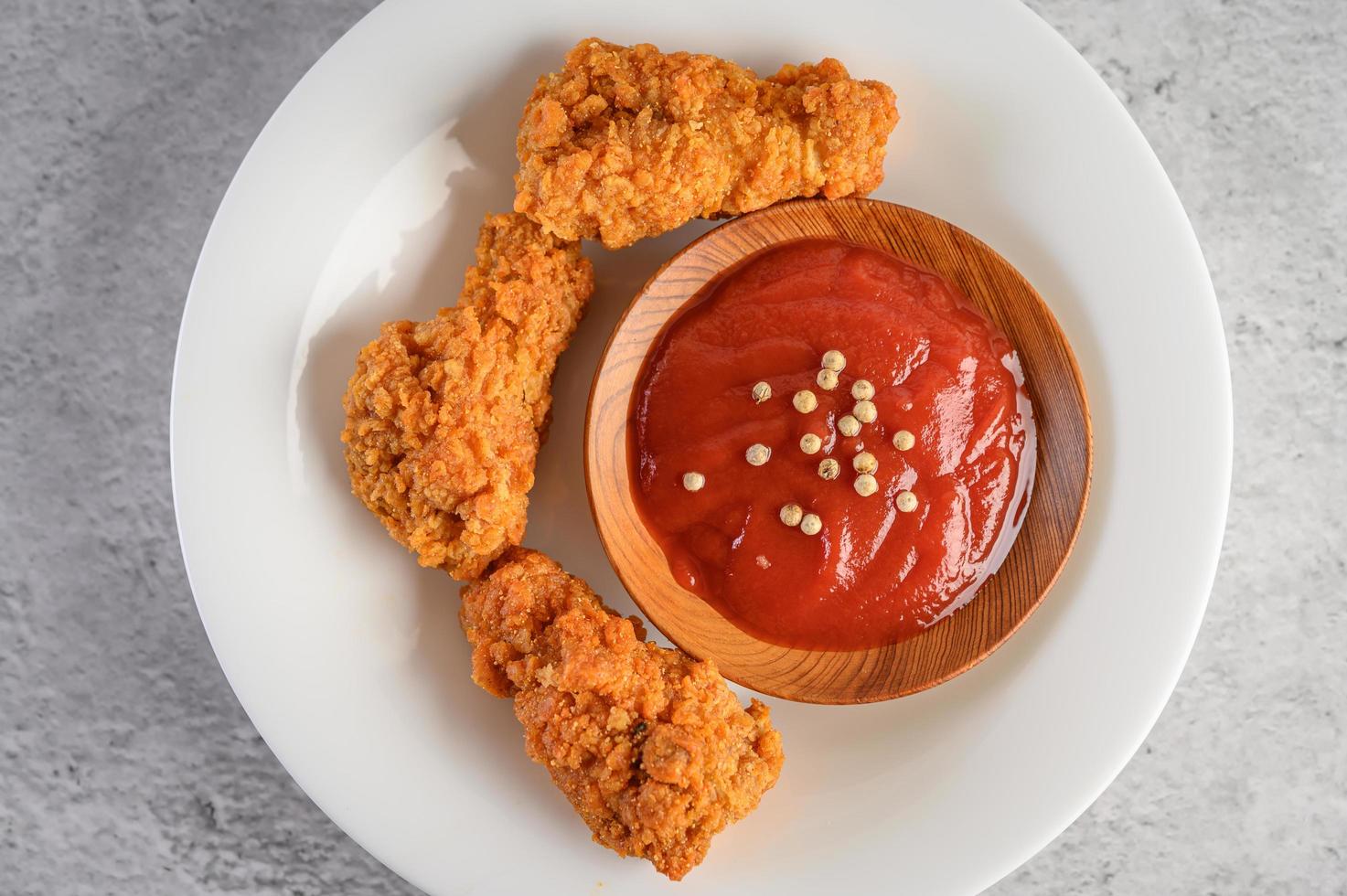 Crispy fried chicken with tomato sauce photo