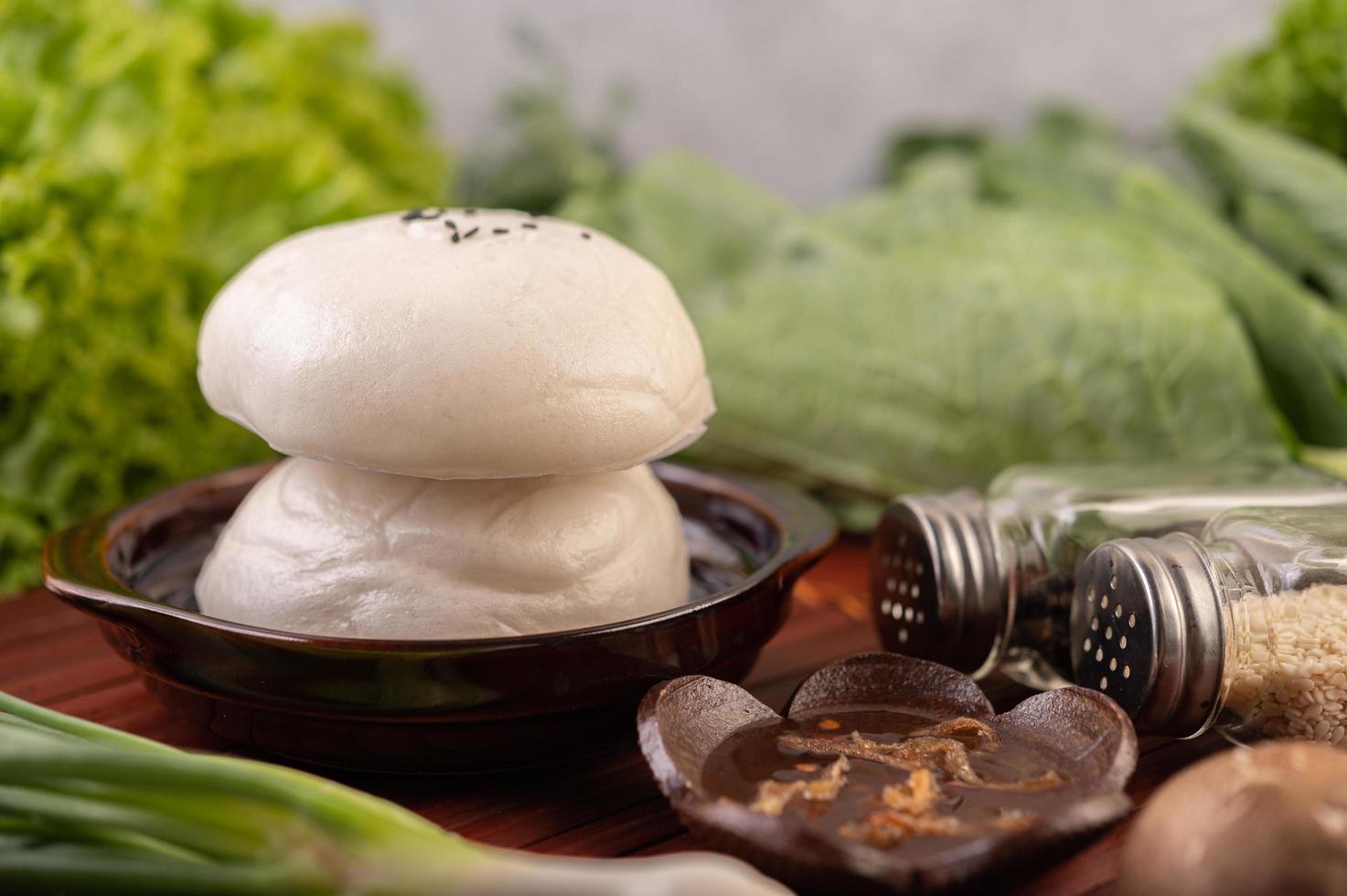 Steamed buns in a wooden dish photo