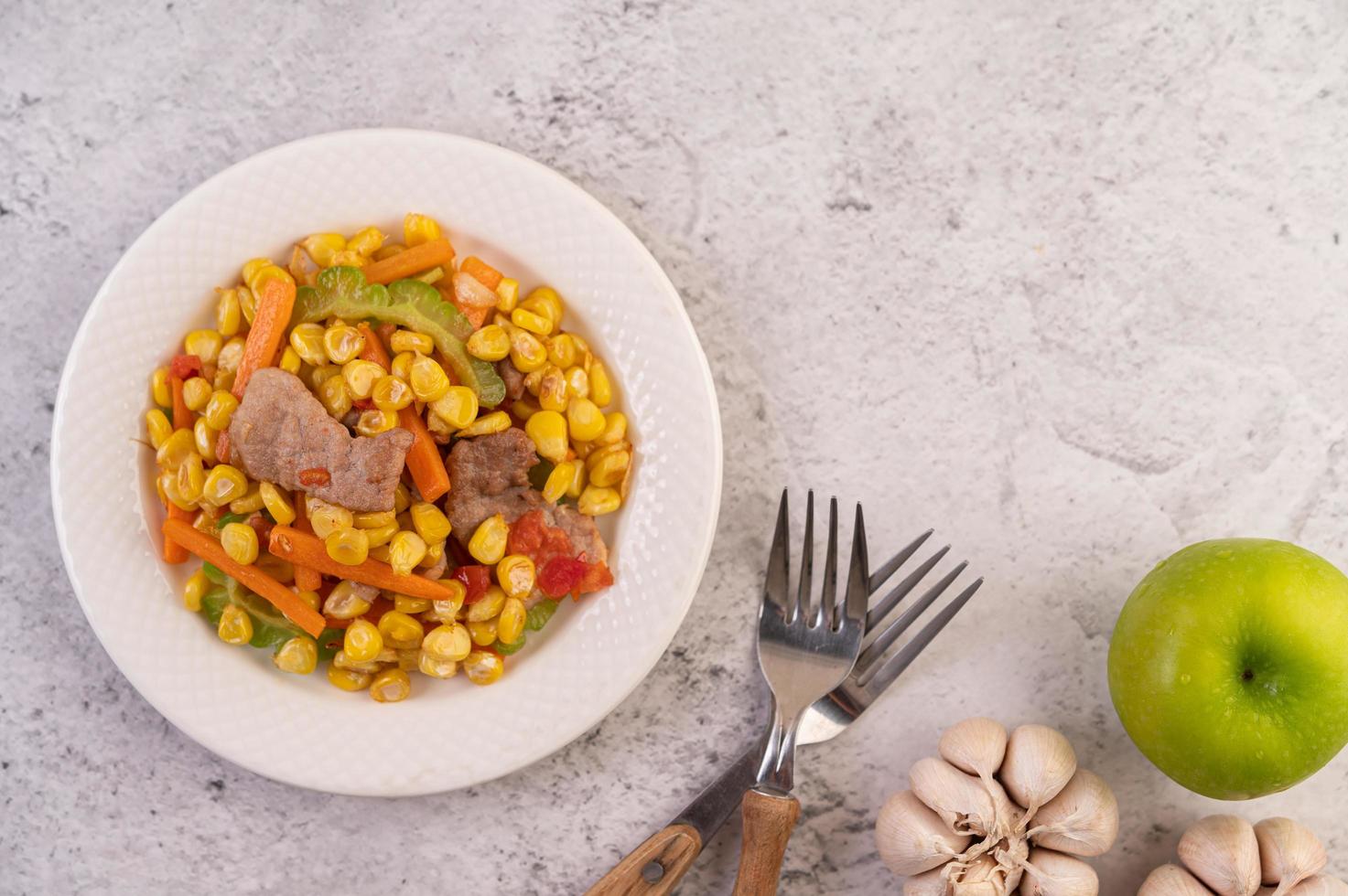 Pork dish with carrots and corn photo