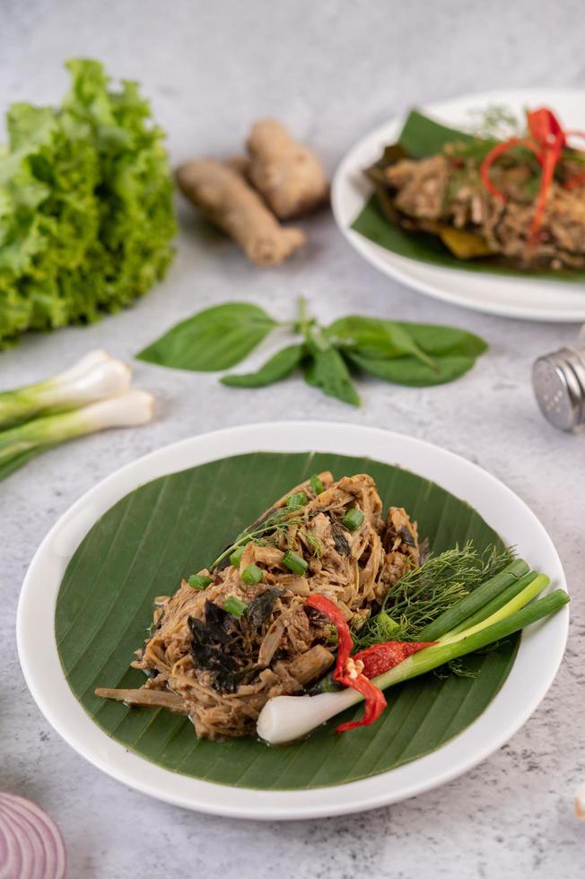 Thai mok bamboo shoots on a banana leaf photo