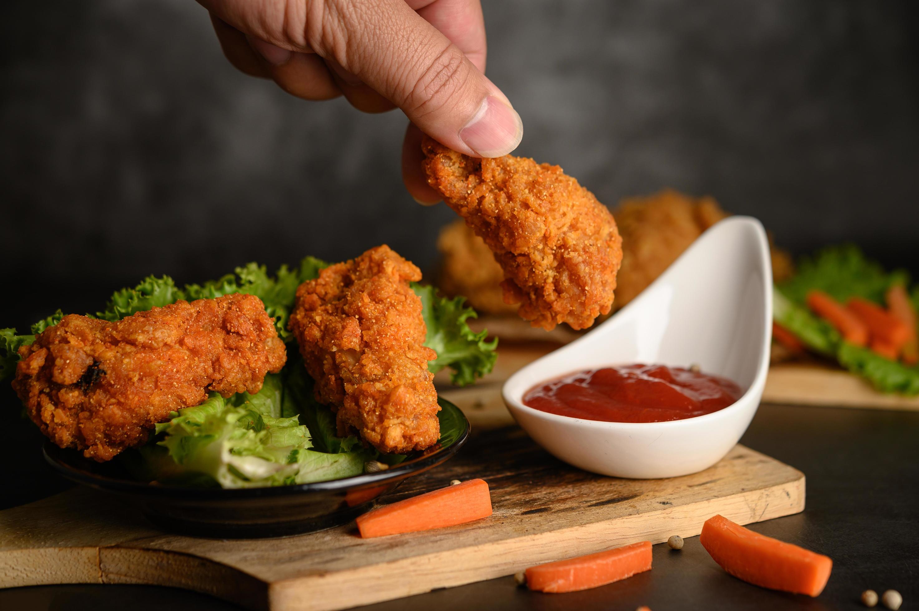 Hand dipping crispy fried chicken 1827110 Stock Photo at Vecteezy