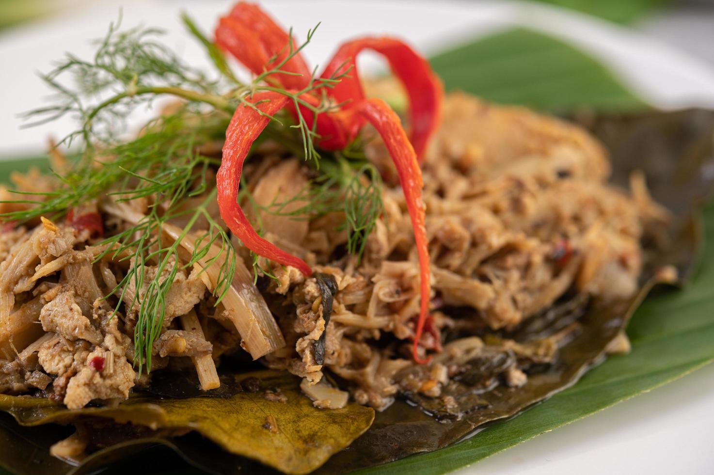 Thai mok bamboo shoots on a banana leaf photo