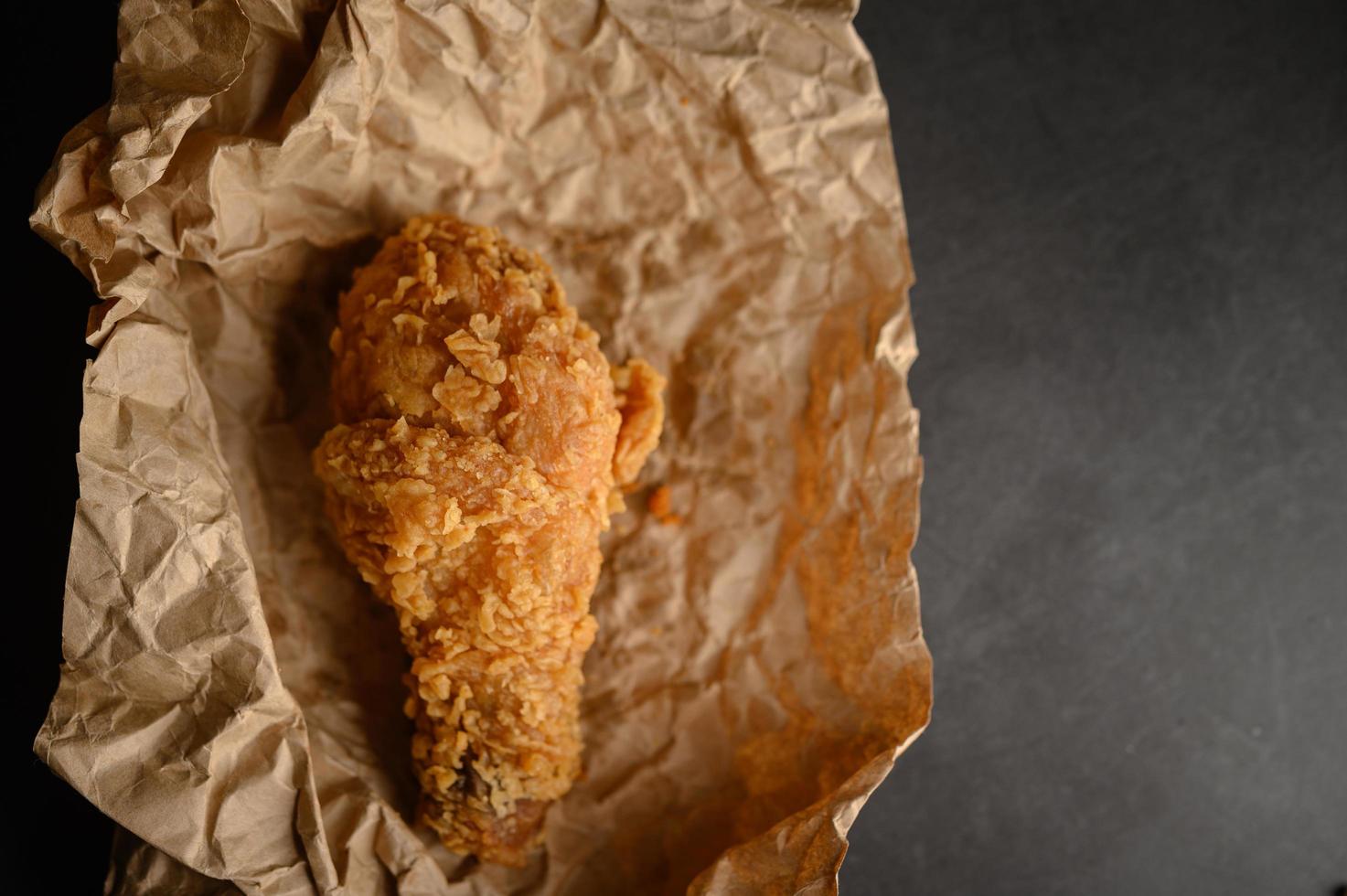 Crispy fried chicken on brown paper photo