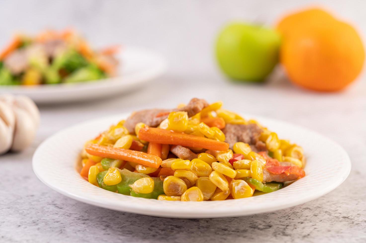 Pork dish with carrots and corn photo