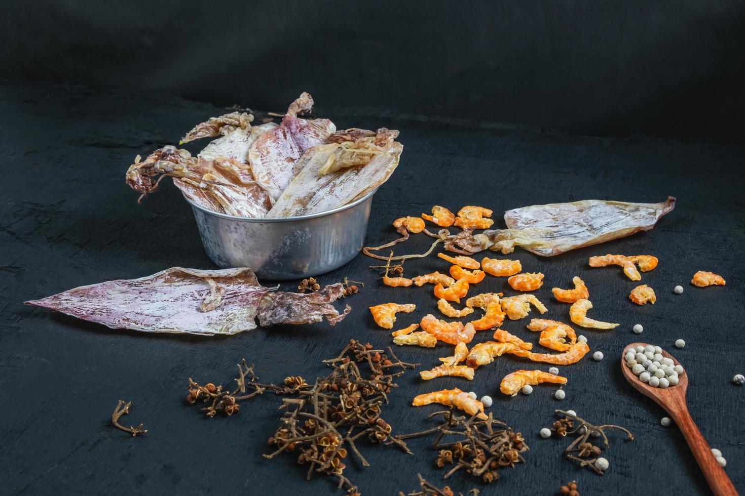 Dried seafood on a black wooden table photo