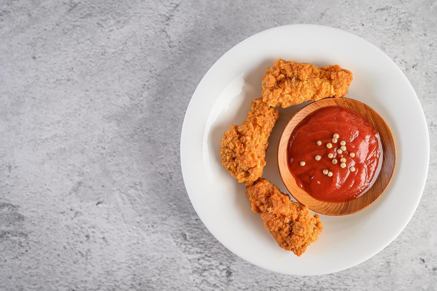 Crispy fried chicken with tomato sauce photo