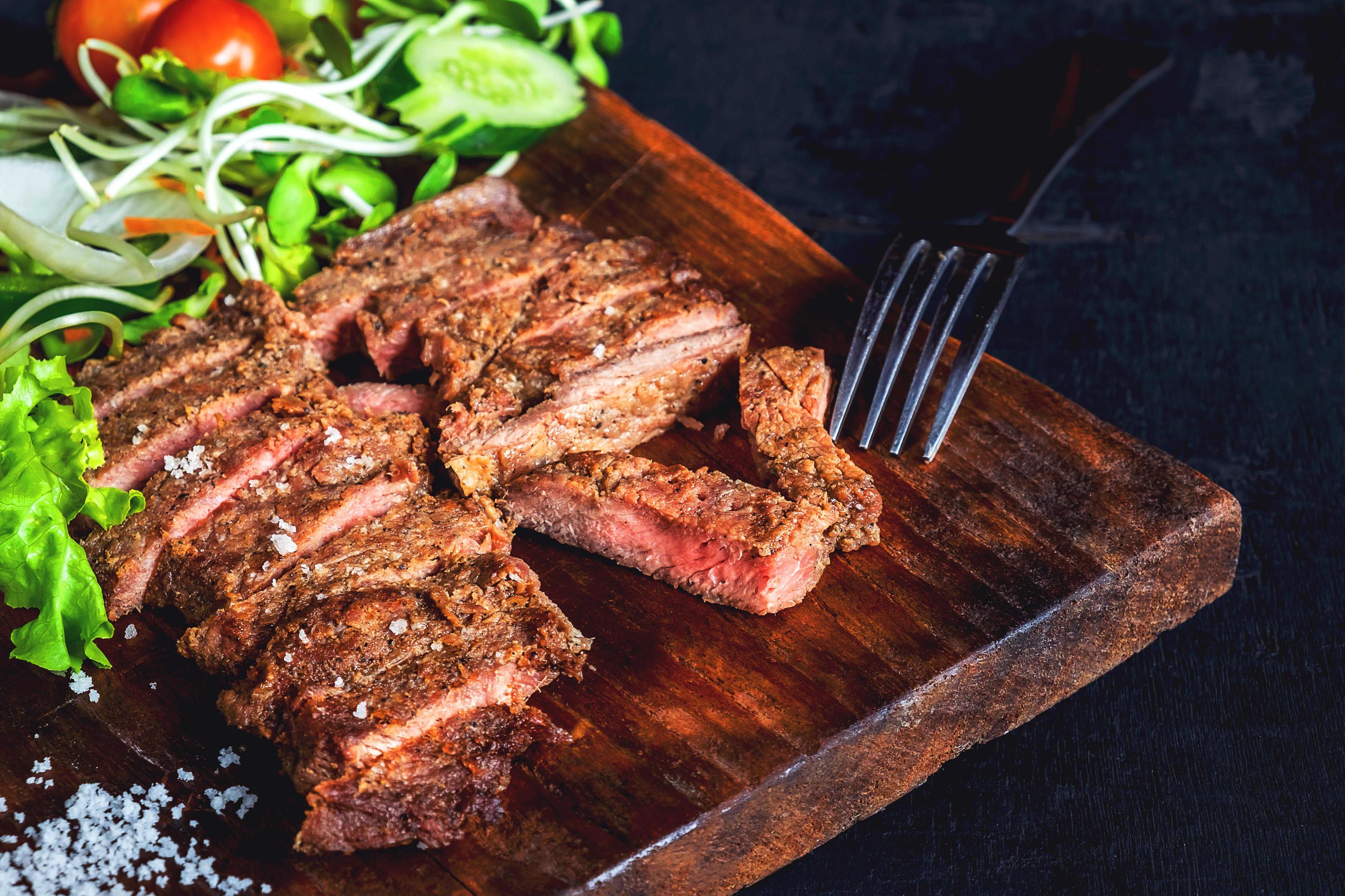 Steak on a wooden plate 1827239 Stock Photo at Vecteezy