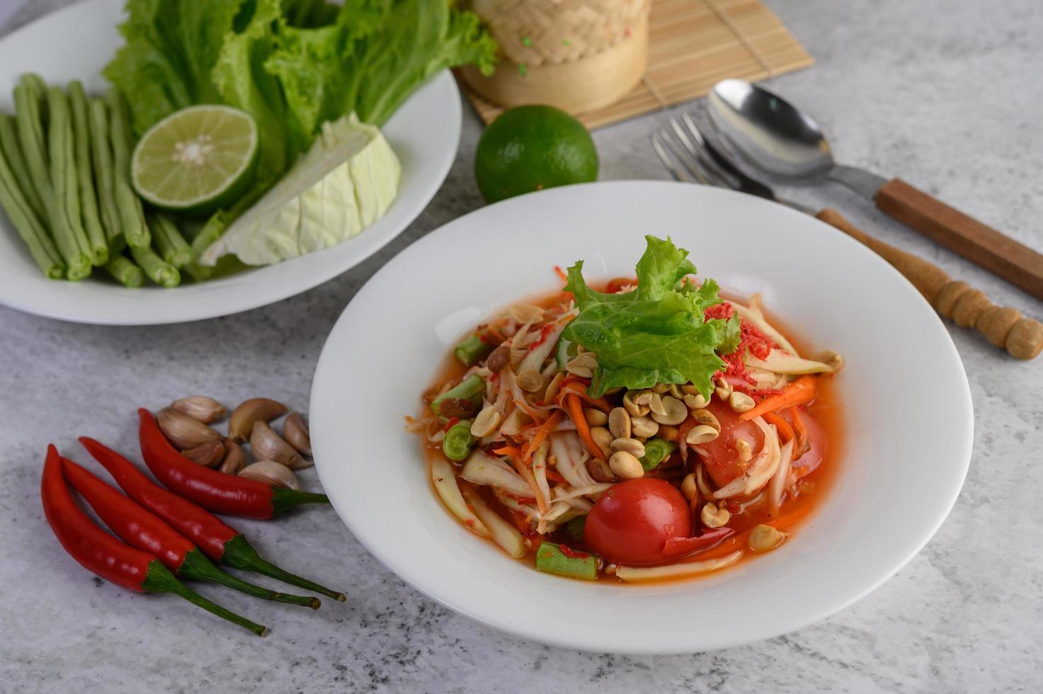 Thai papaya salad with ingredients photo