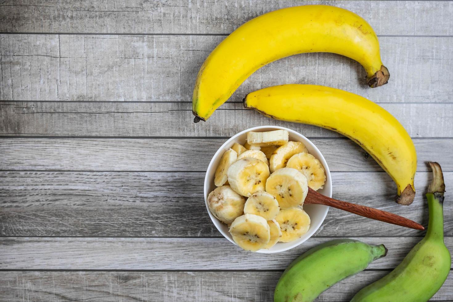 Top view of sliced and whole bananas photo