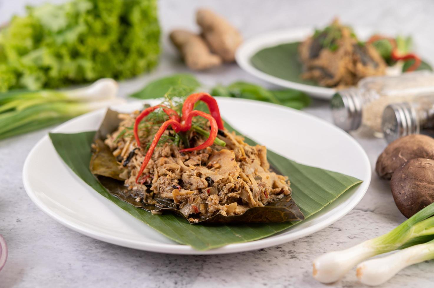 Thai mok bamboo shoots on a banana leaf photo