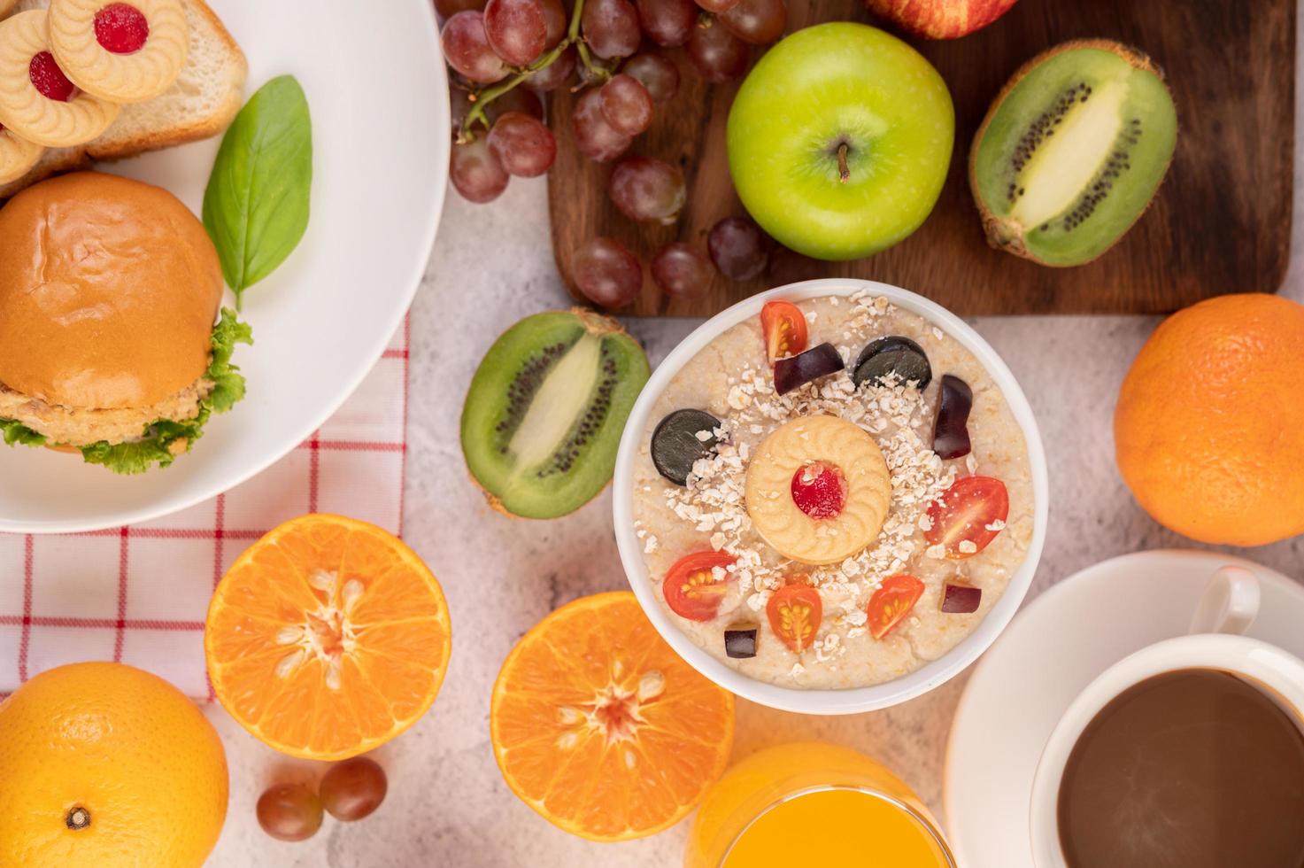 Dessert cup with apples, kiwi, orange, and grapes photo