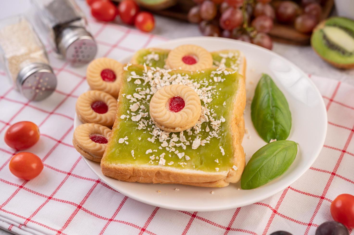 Bread covered with pandan custard and stuffed with dessert photo