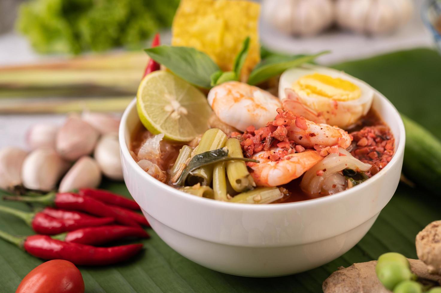 Tom yum noodles with shrimp and boiled eggs photo