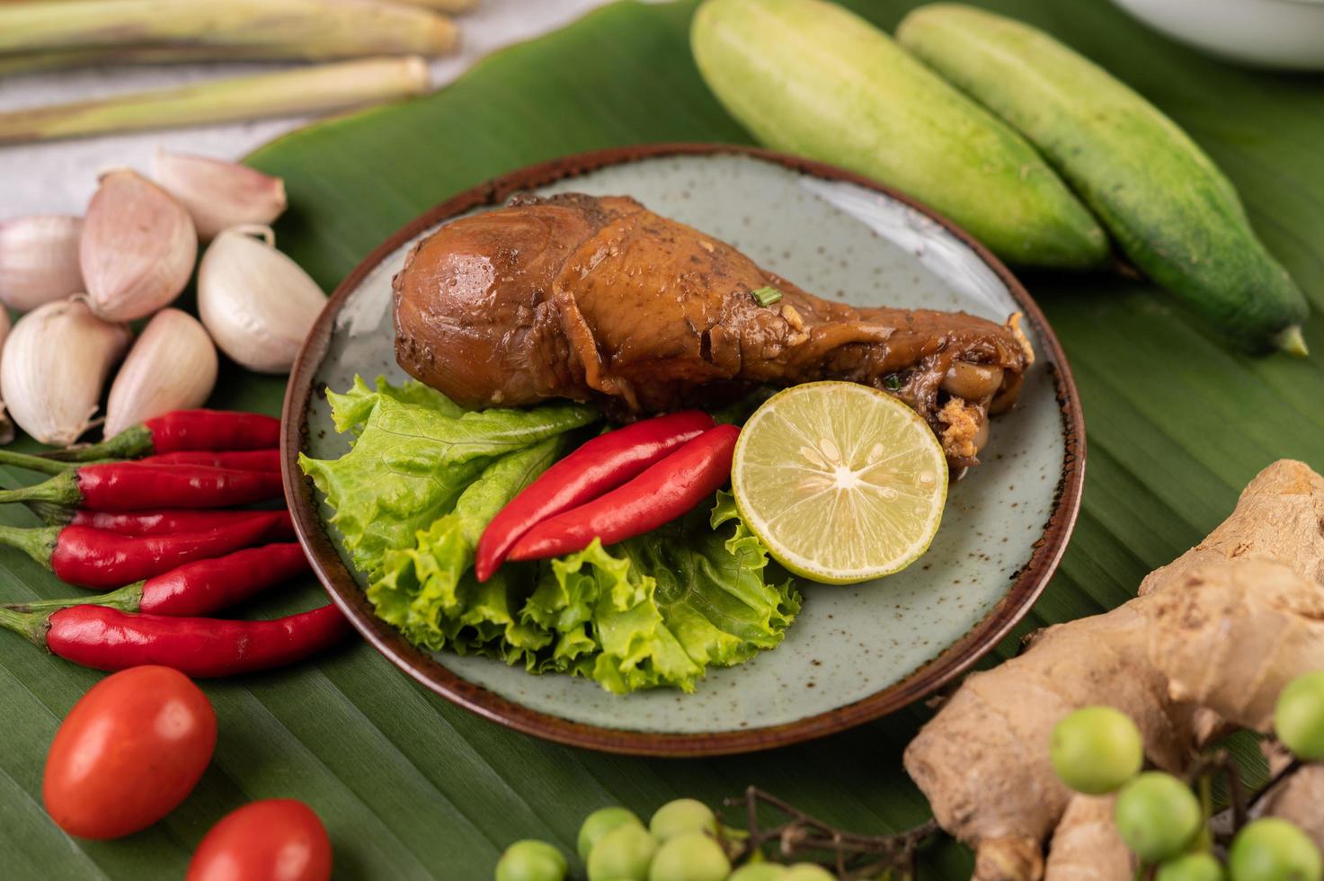 Braised chicken leg with lettuce, chili and lime photo