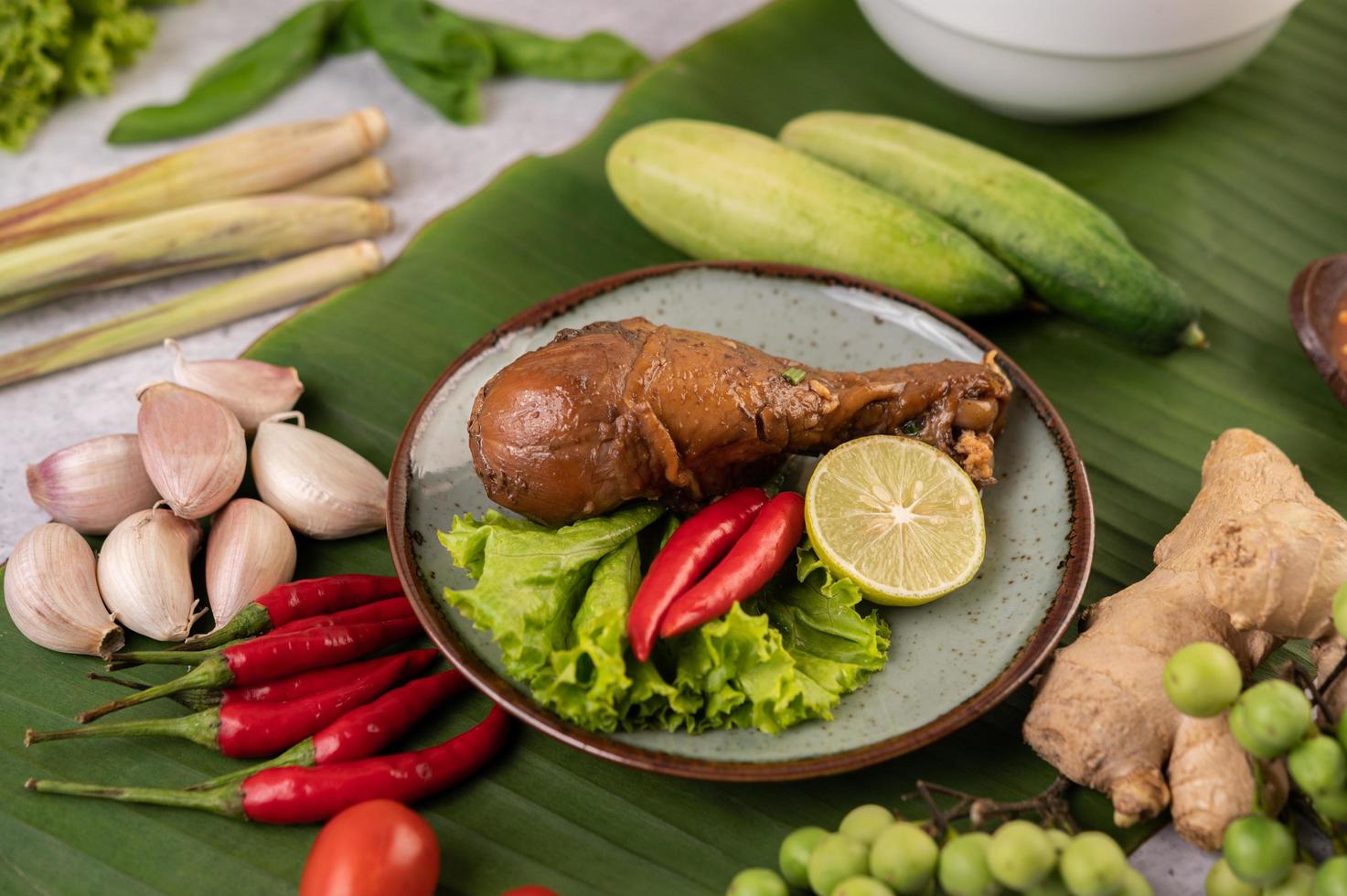 Braised chicken leg with lettuce, chili and lime photo