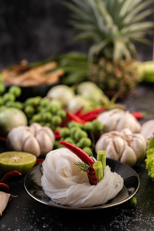 Rice noodles with beans, tomatoes, melon and chilies photo