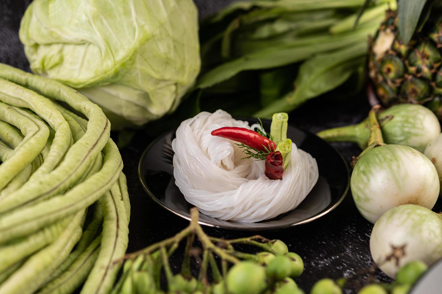 Rice noodles with beans, tomatoes, melon and chilies photo