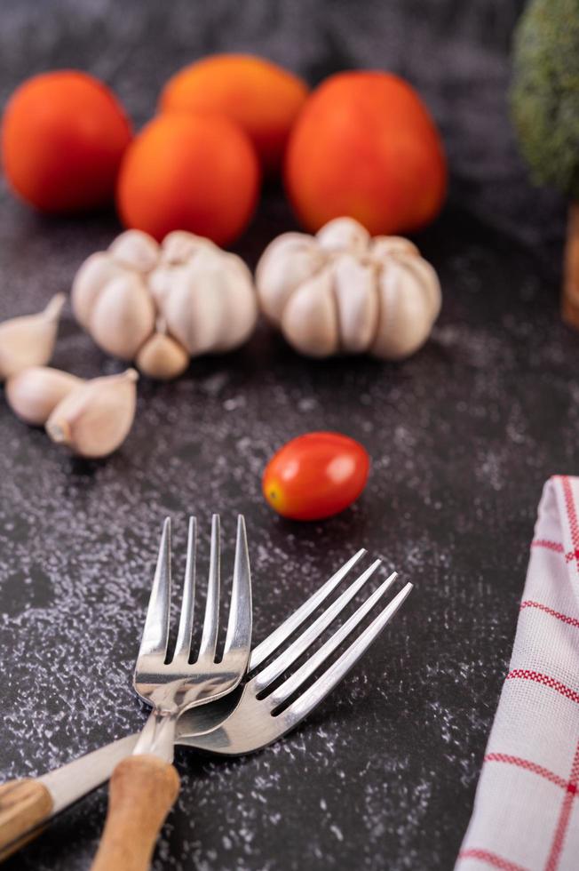 Garlic and tomatoes with two forks photo