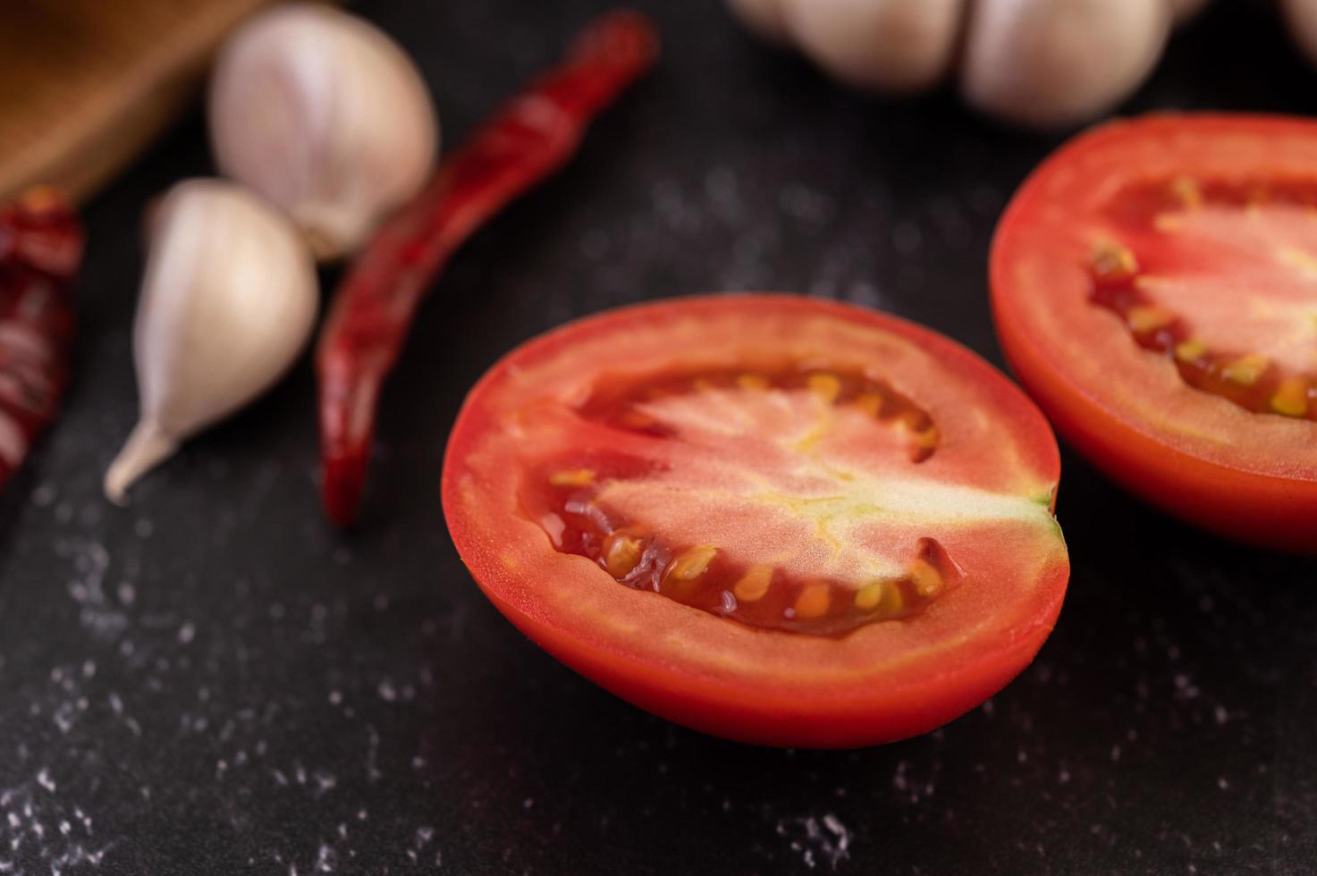 Half-cut tomatoes with chili and garlic photo