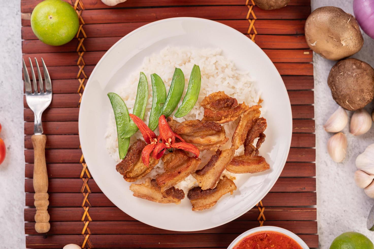 Pork belly on streamed rice with vegetables photo