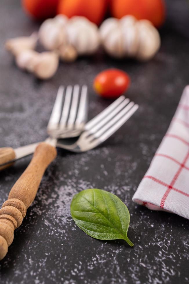 Garlic and tomatoes with two forks photo