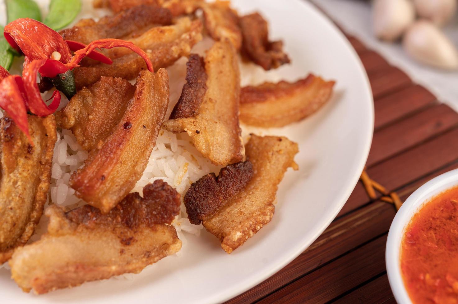 Pork belly on streamed rice with vegetables photo