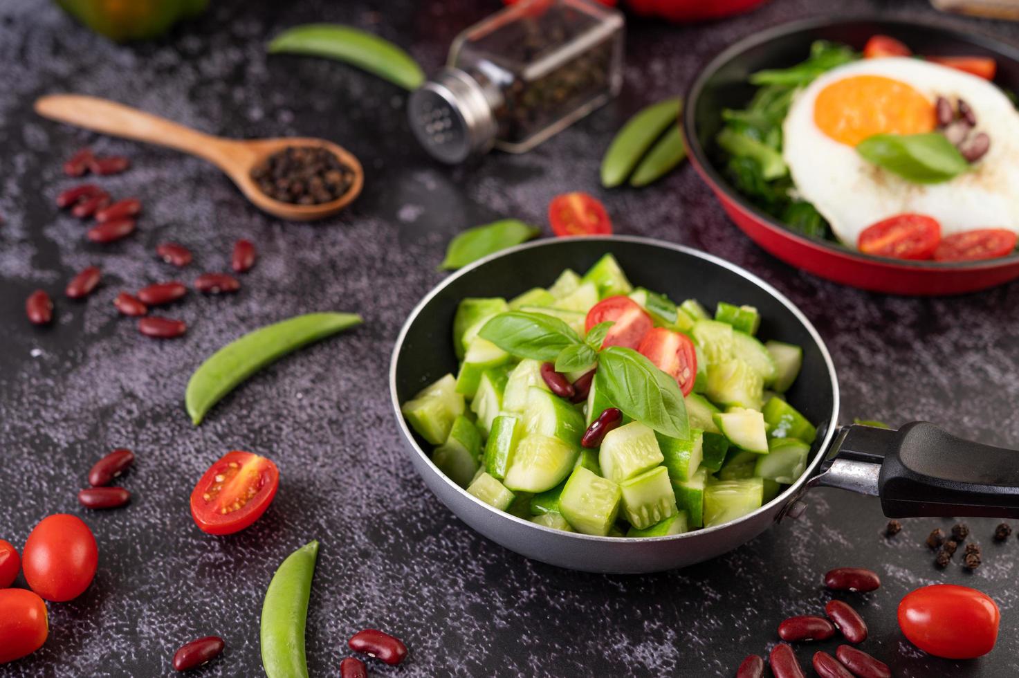 Cucumbers with egg in a frying pan photo