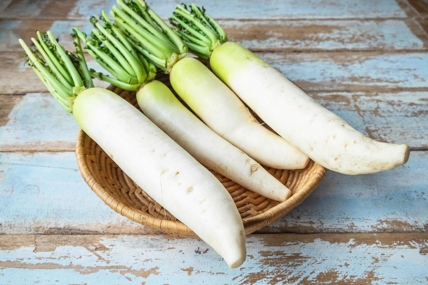 Fresh radishes in a wooden basket photo