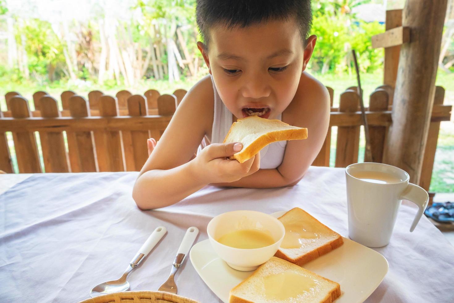 Boy eating bread photo