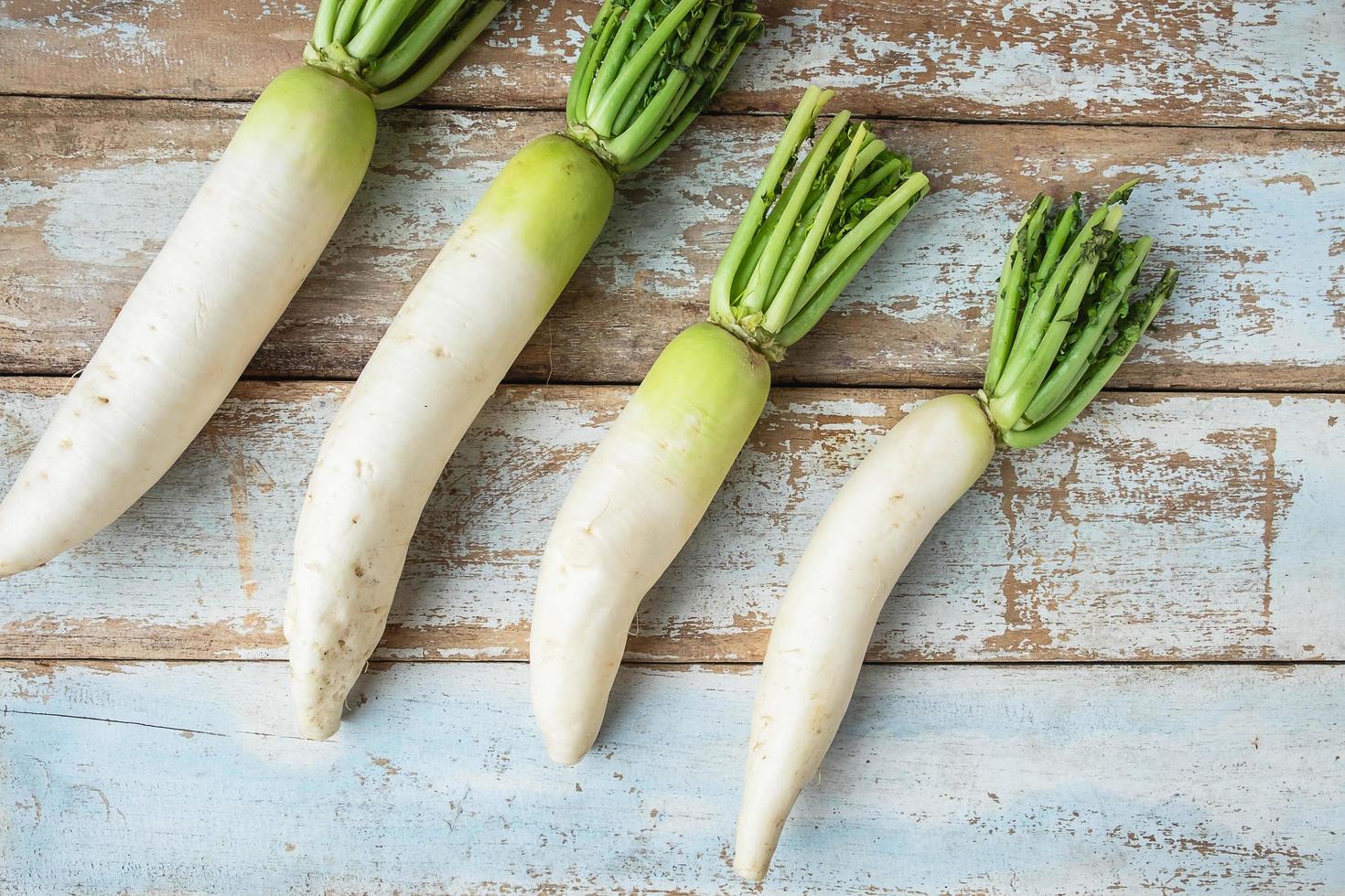 Radishes on a blue wooden background photo