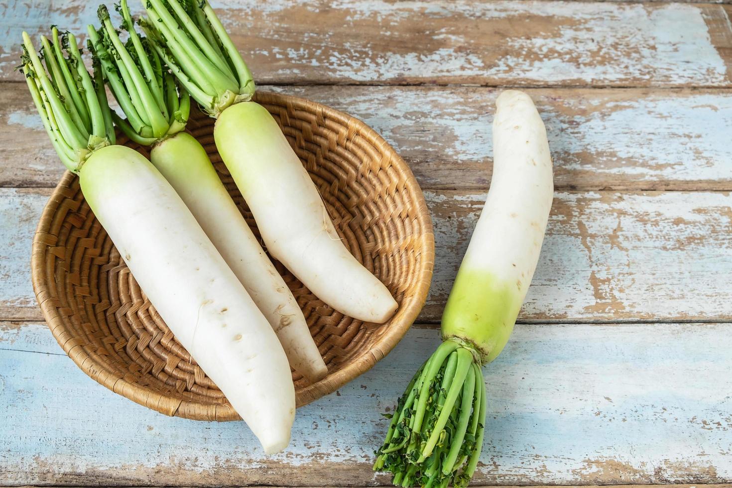 Radishes in a wooden basket photo